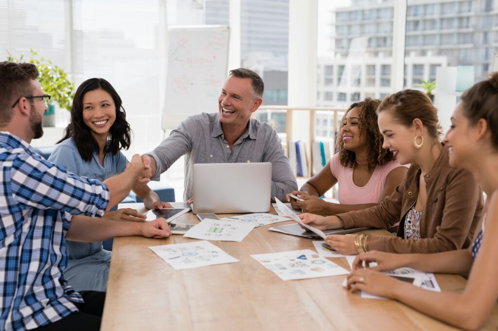 Executives shaking hands in the meeting